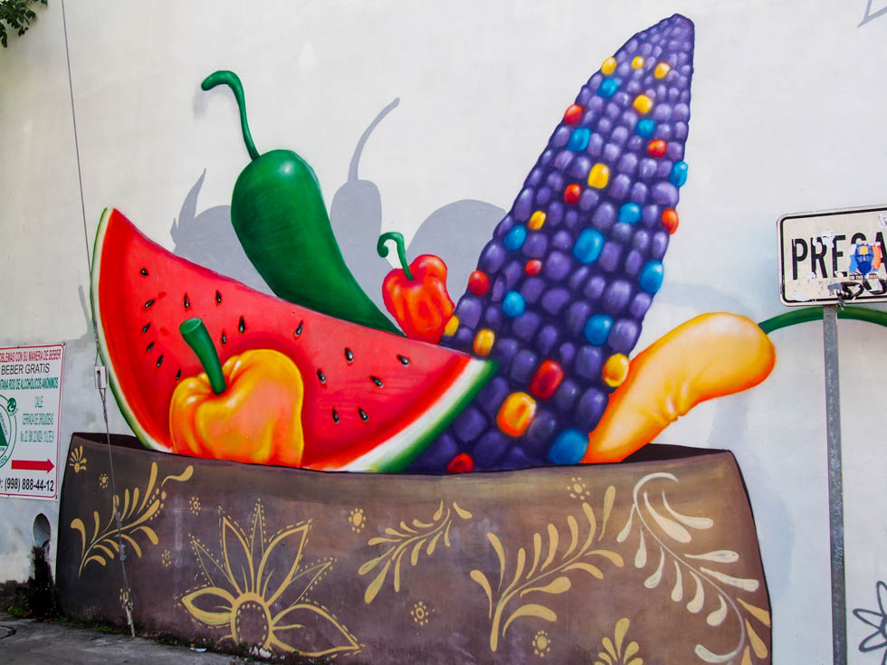 Street art in Cancun, Mexico depicting various fruits and vegetables in a dish