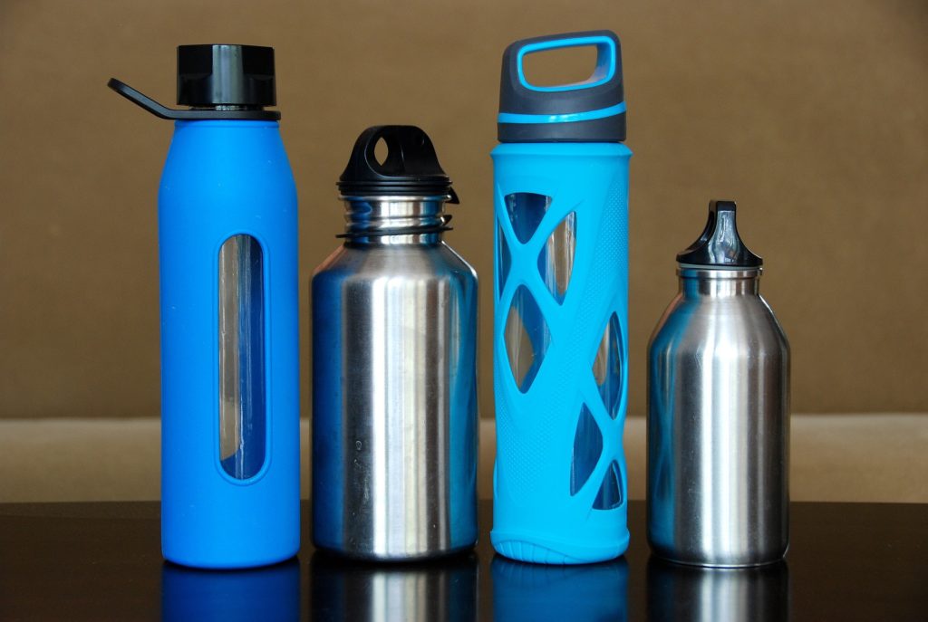 4 reusable water bottles of various sizes in a row