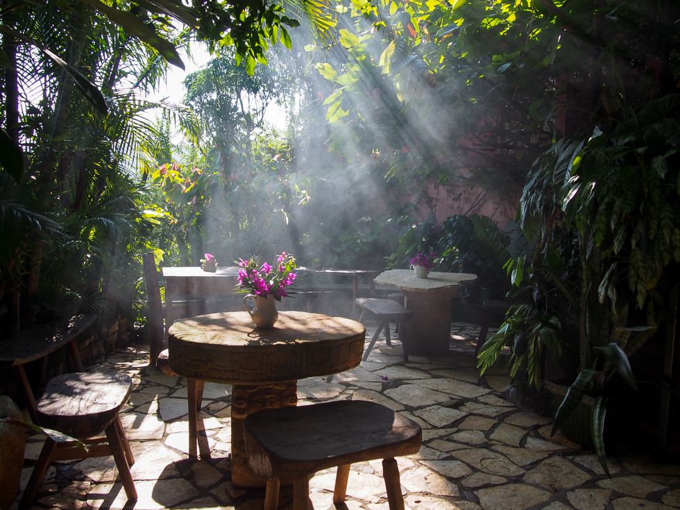 Sunlight streaming down over an empty cafe during the golden hour at El Lugar Del Te & Chocolate