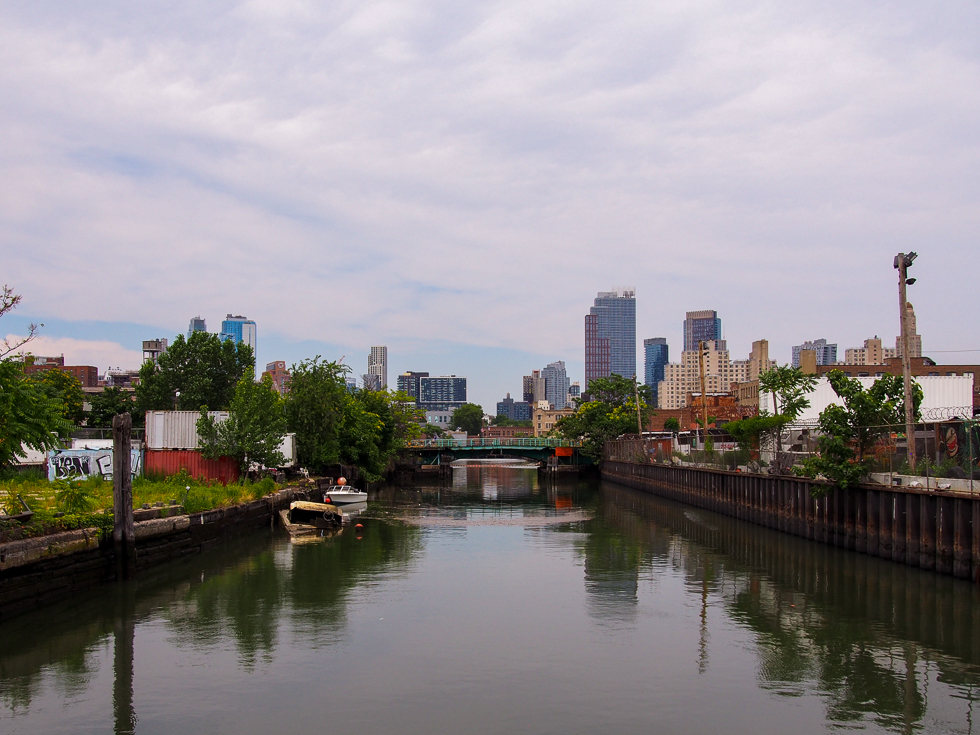 Example of water conservation activities during travel: canoeing in the Gowanus Canal in Brooklyn, with the Brooklyn skyline in the distance