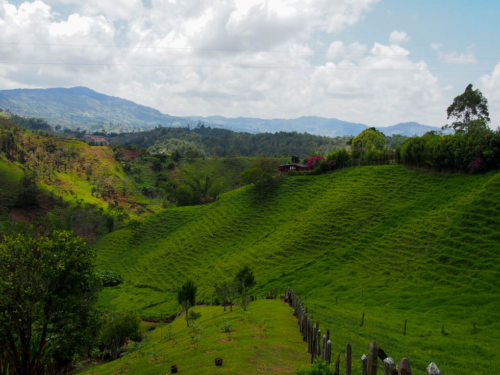 Rolling green hills near Guatape, Colombia, with mountains in the distance